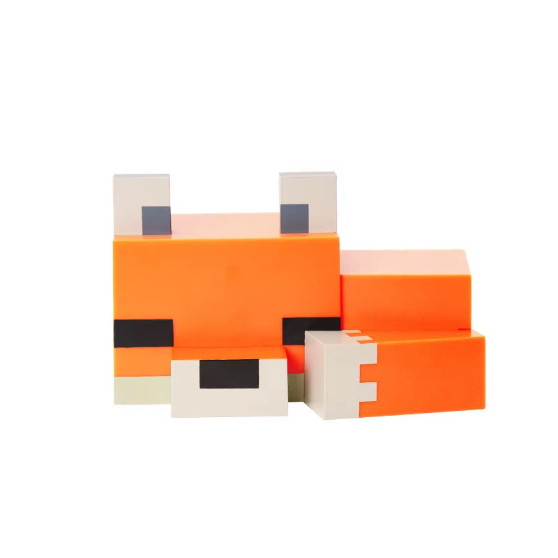 Pixel fox night light with soft orange glow on a desk