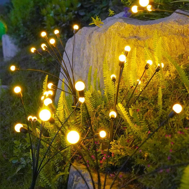 Waterproof solar firefly stakes in flower bed